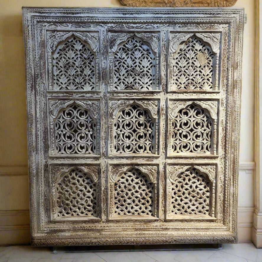 A handcrafted wooden panel featuring intricate carvings, showcasing traditional Rajasthani motifs.