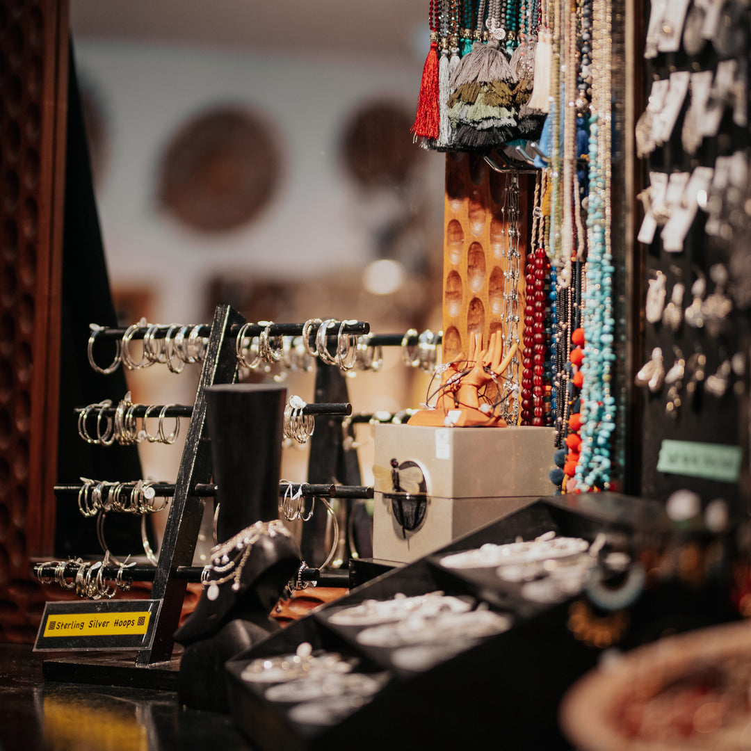 Jewelry display with necklaces and earrings in a store setting