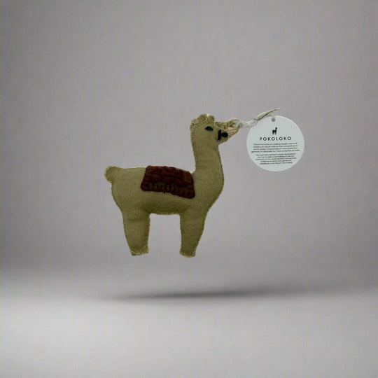 Small plush llama toy with a brown patch on a white background