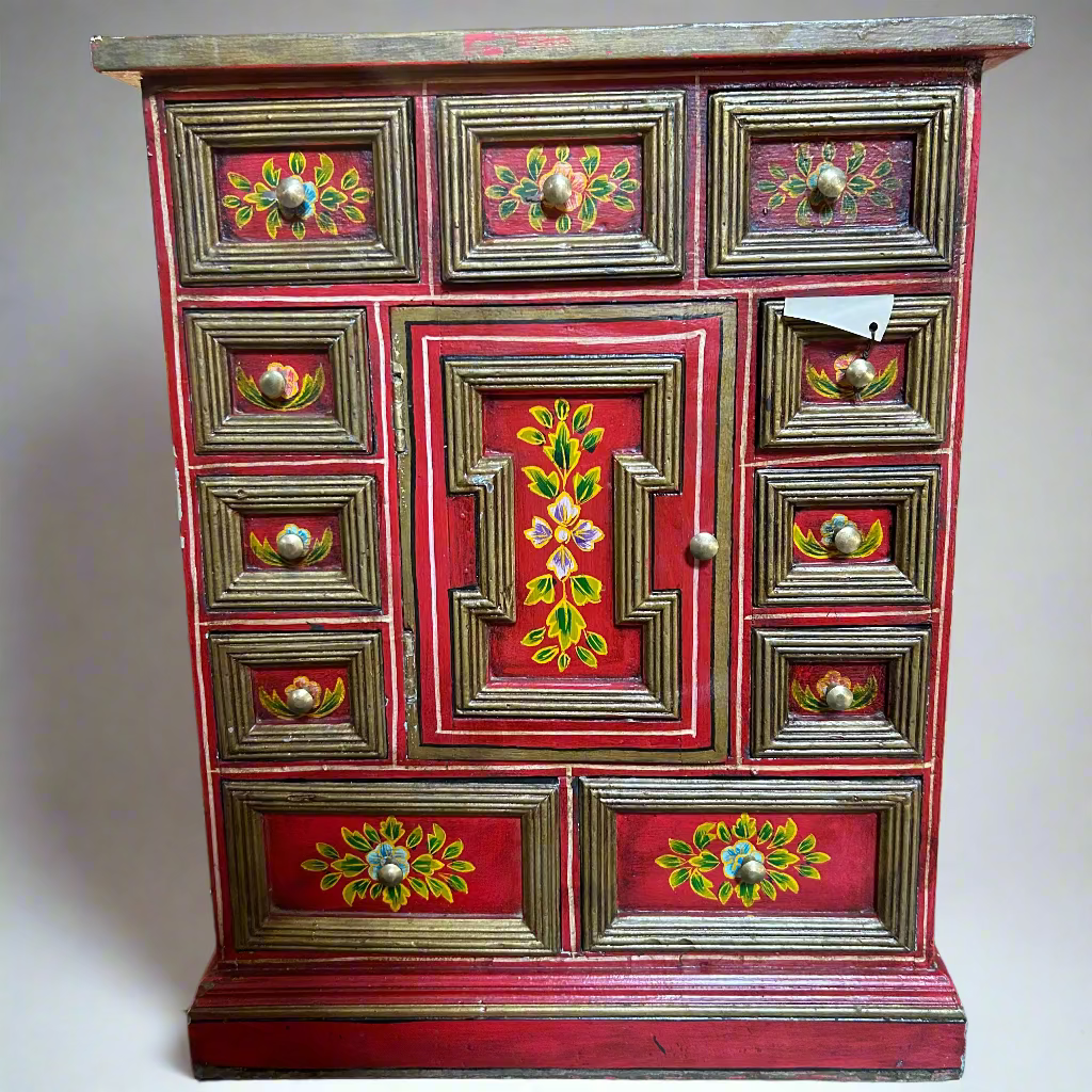 Decorative red cabinet with floral patterns
