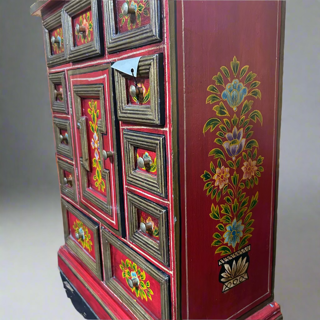 Decorative red cabinet with floral patterns
