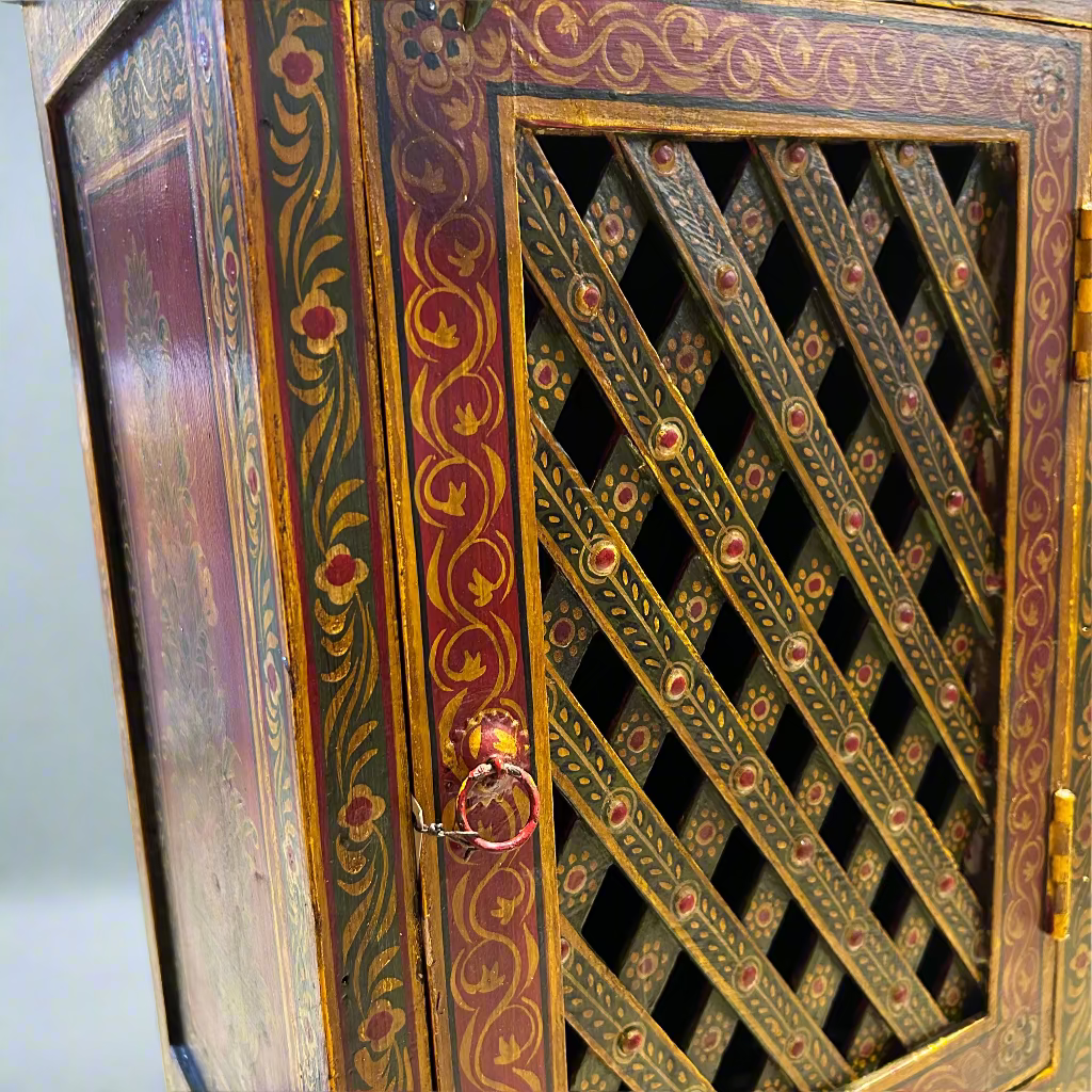 Decorative wooden cabinet with intricate lattice design and gold accents