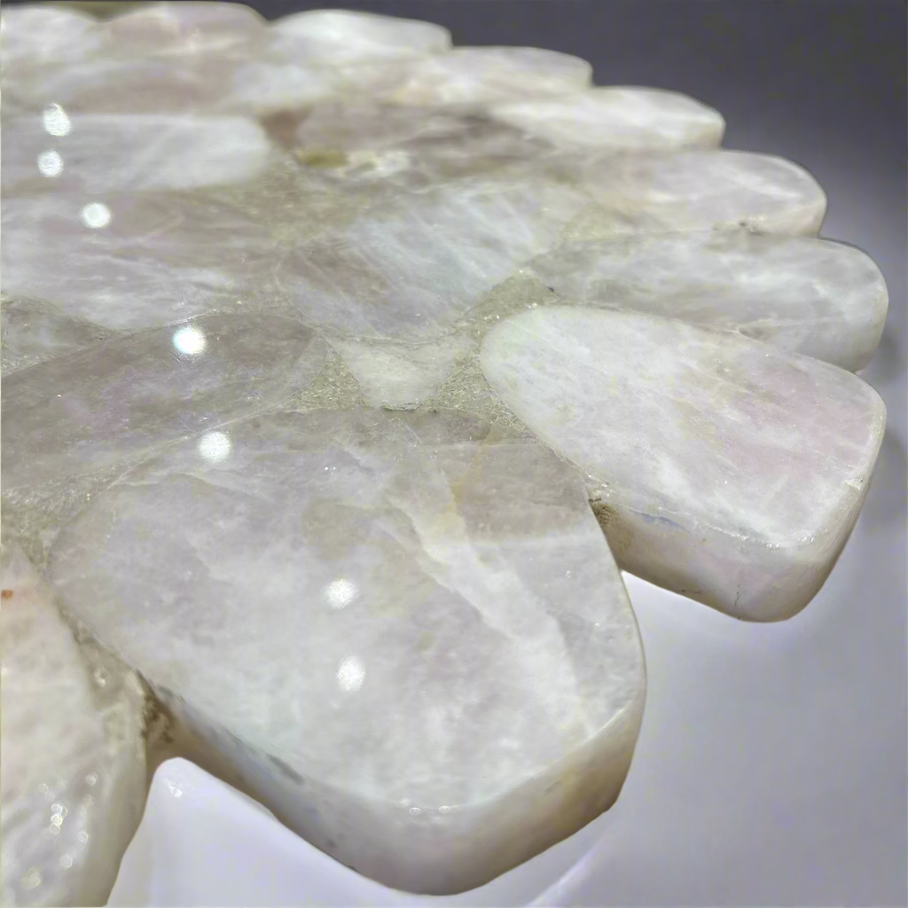 Close-up of a white stone sculpture with a blurred background