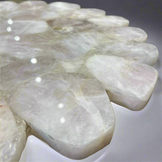 Close-up of a white stone sculpture with a blurred background