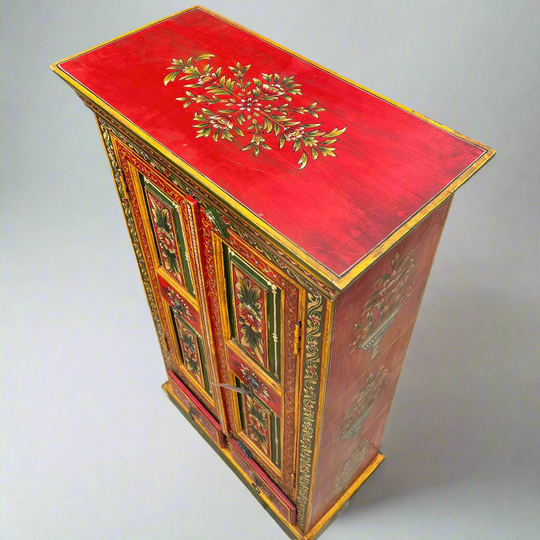 Decorative wooden cabinet with red top and intricate designs