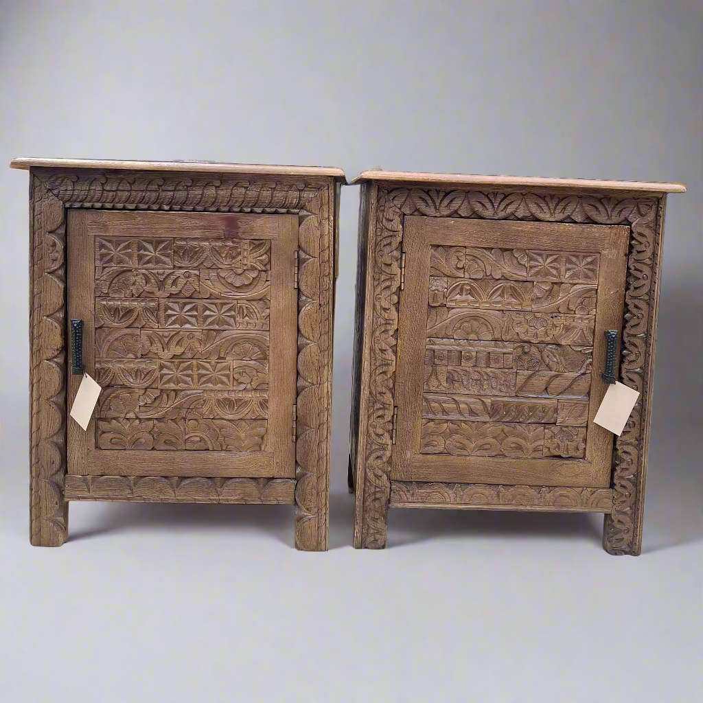 Two wooden cabinets with intricate carvings