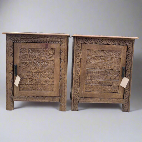Two wooden cabinets with intricate carvings