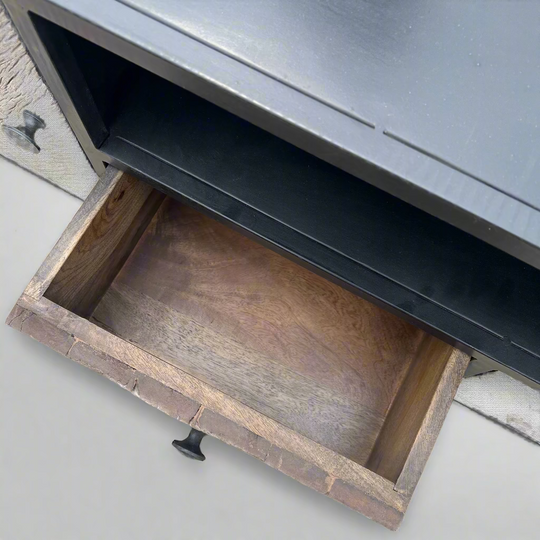 Open drawer of a dark  wooden cabinet