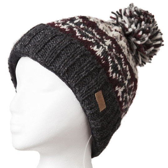 A wool beanie hat with a pom-pom, featuring a maroon and white color pattern, displayed on a mannequin head.