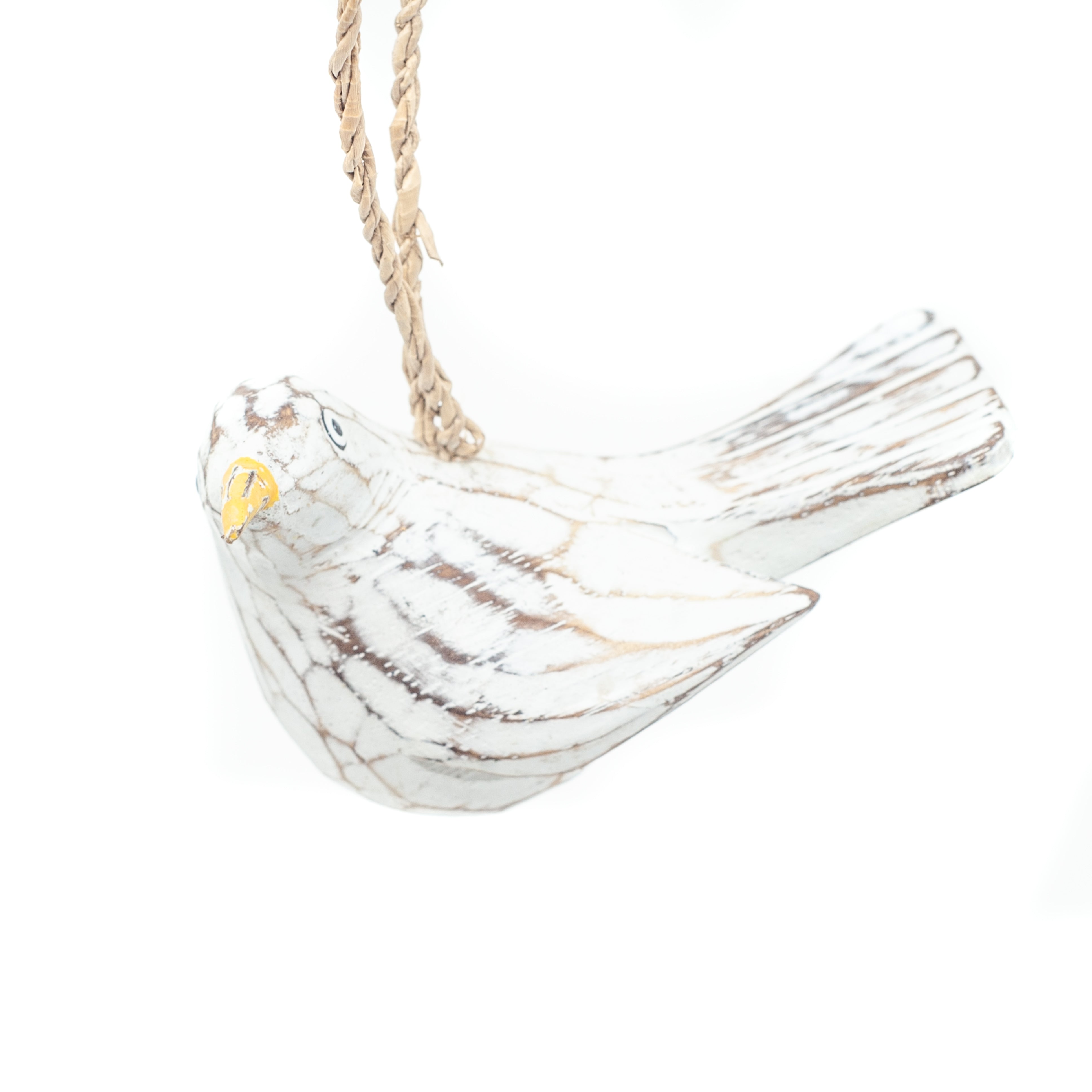 Small driftwood bird ornament on white background hanging from string.