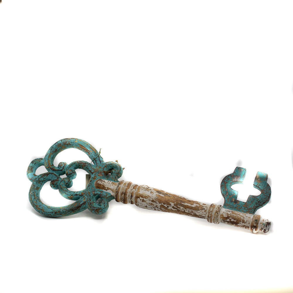 Wooden key in a green colour on white background