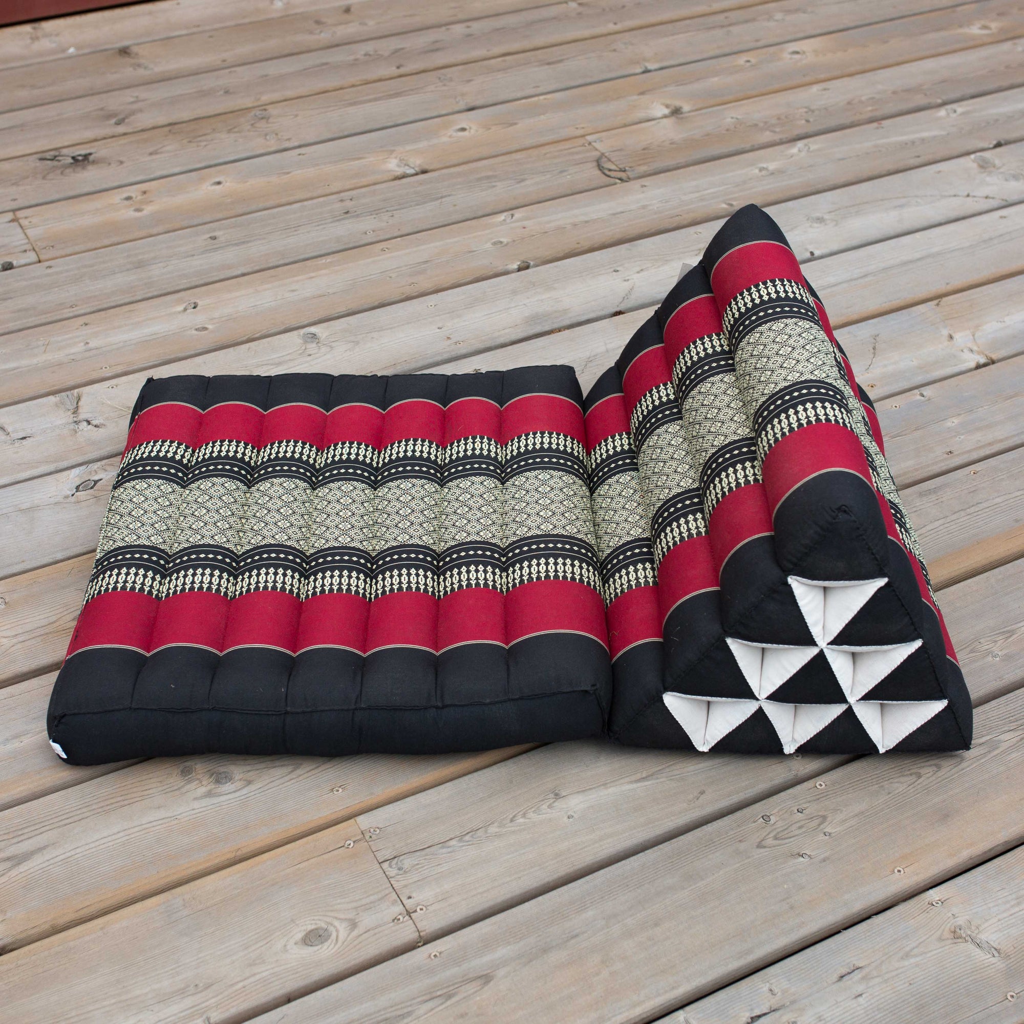 Photo of a folding yoga cushion in various positions, a black colour and a red/orange colour