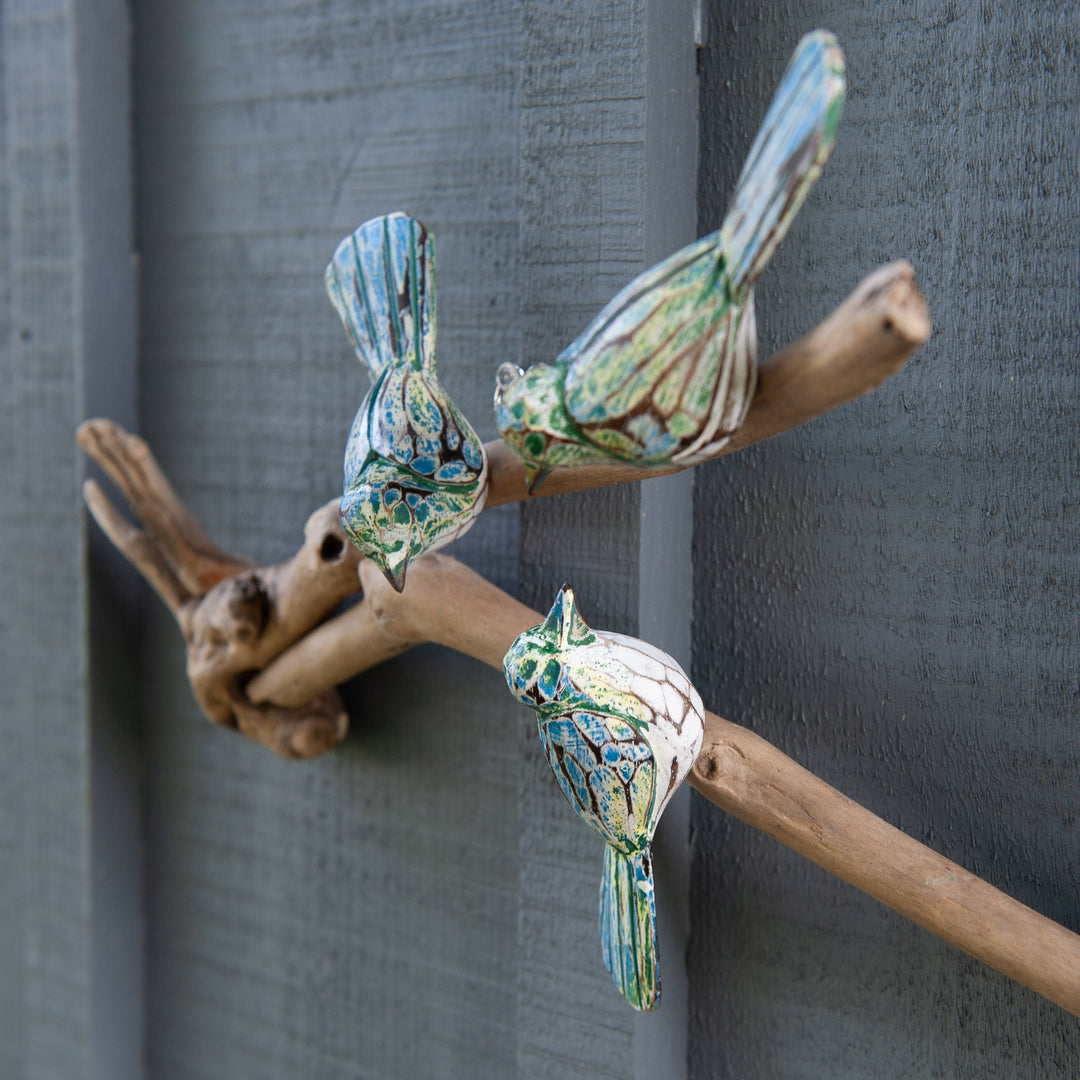 Three Green Birds on Driftwood