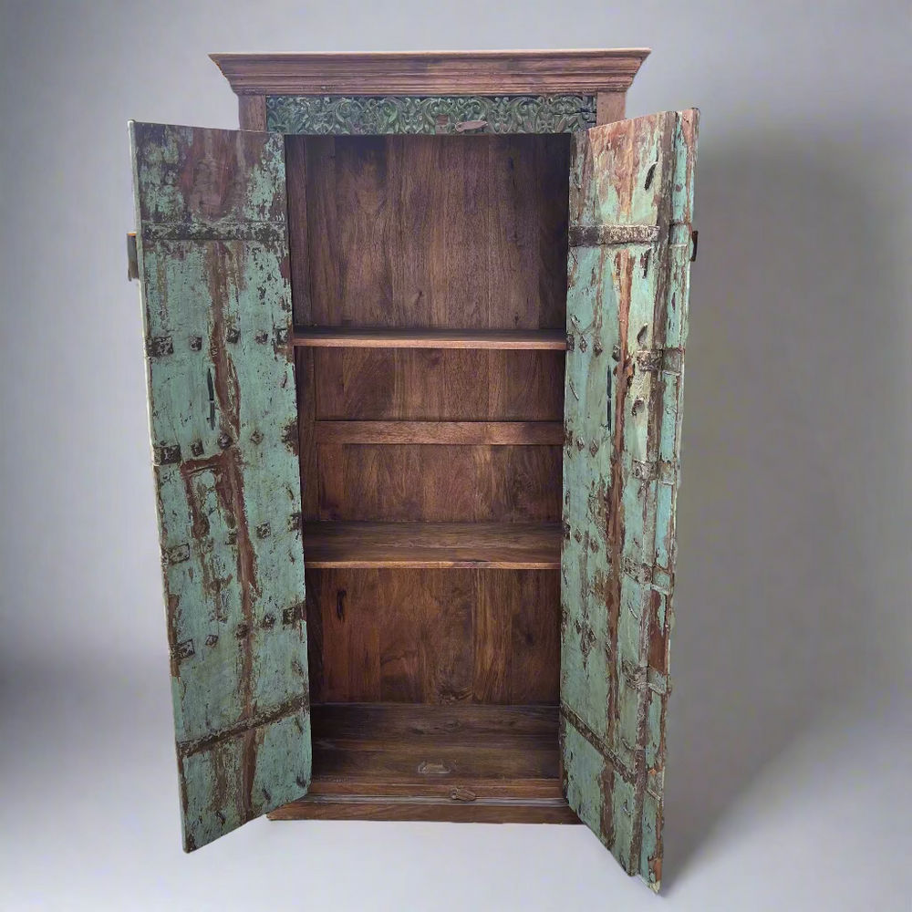 Wooden cabinet with weathered green doors 