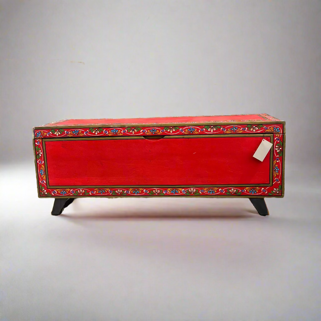 Red wooden chest with decorative patterns 