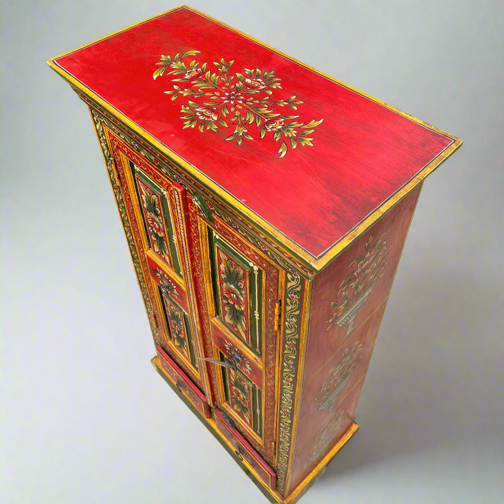 Decorative wooden cabinet with red top and intricate designs 