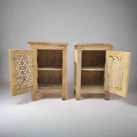 Two wooden cabinets with decorative latticework doors 
