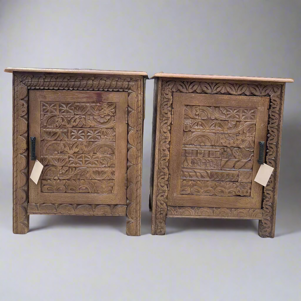 Two wooden cabinets with intricate carvings 