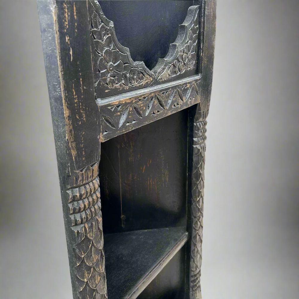 Decorative wooden shelf with intricate carvings 