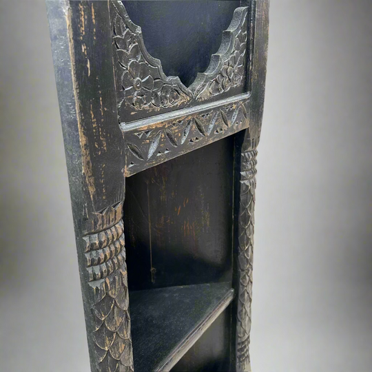 Decorative wooden shelf with intricate carvings 