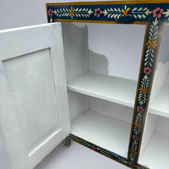 White cabinet with floral decorative trim 