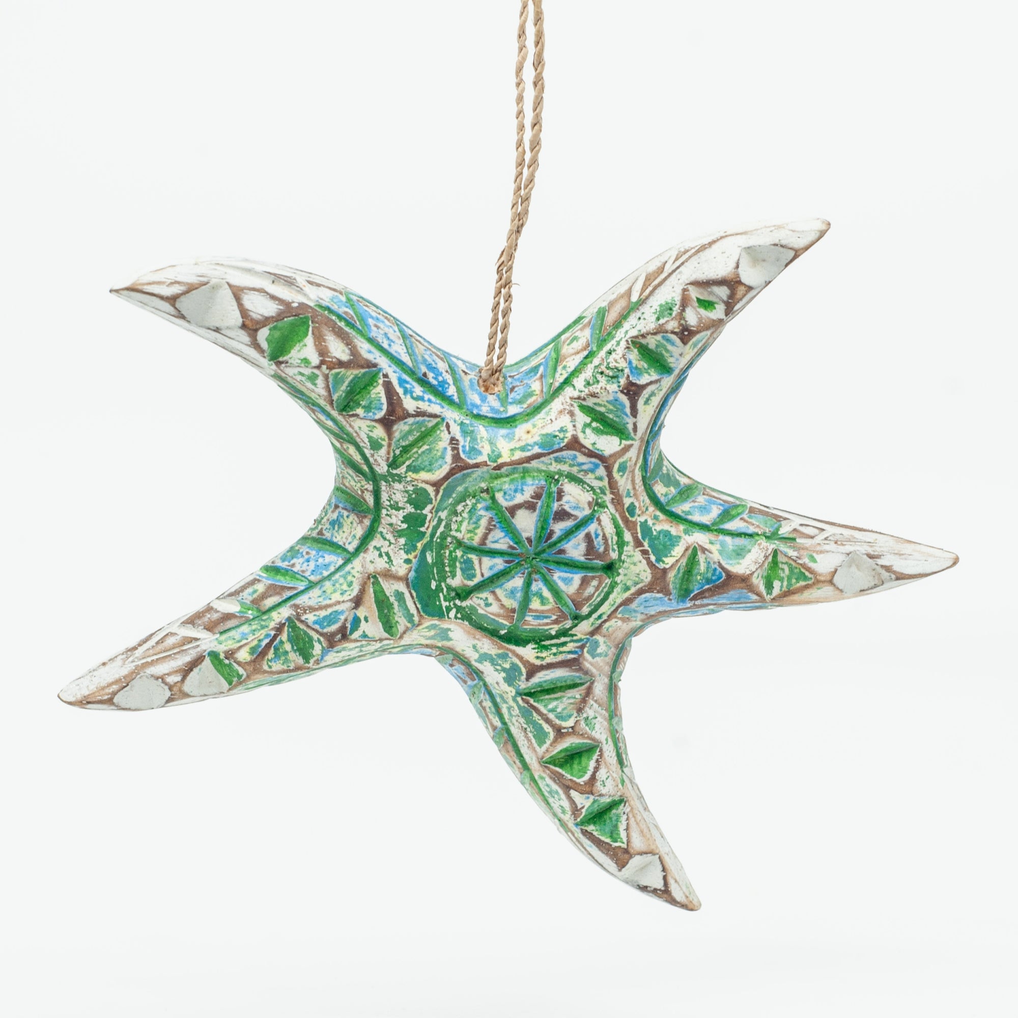 Small driftwood starfish ornament on white background hanging from string. 