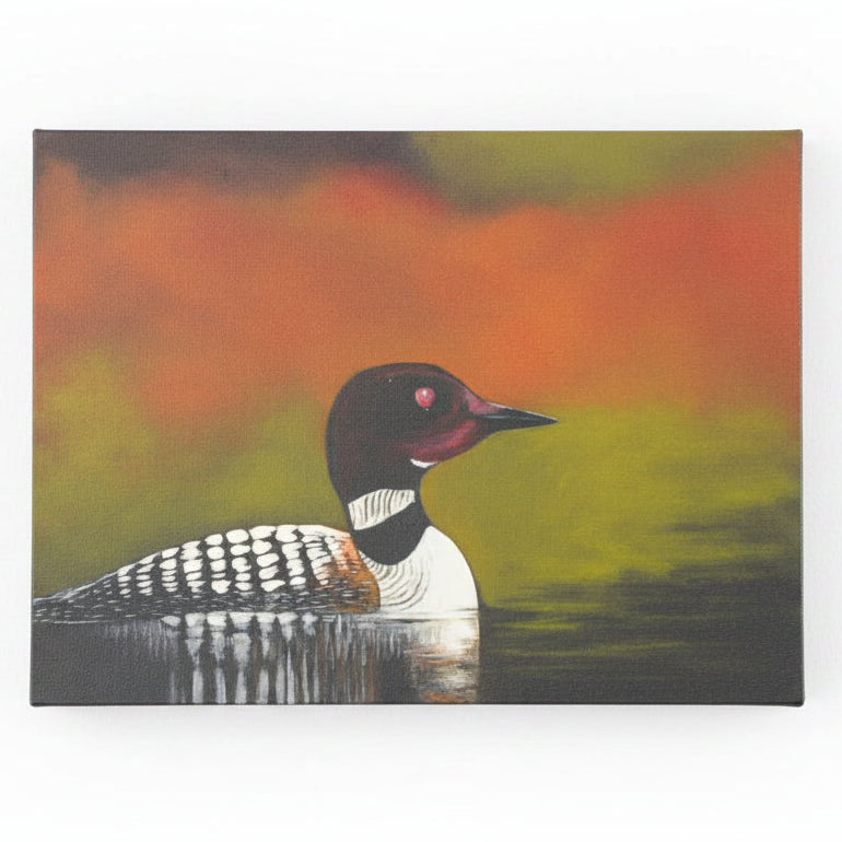 Loon on calm water with fall colours