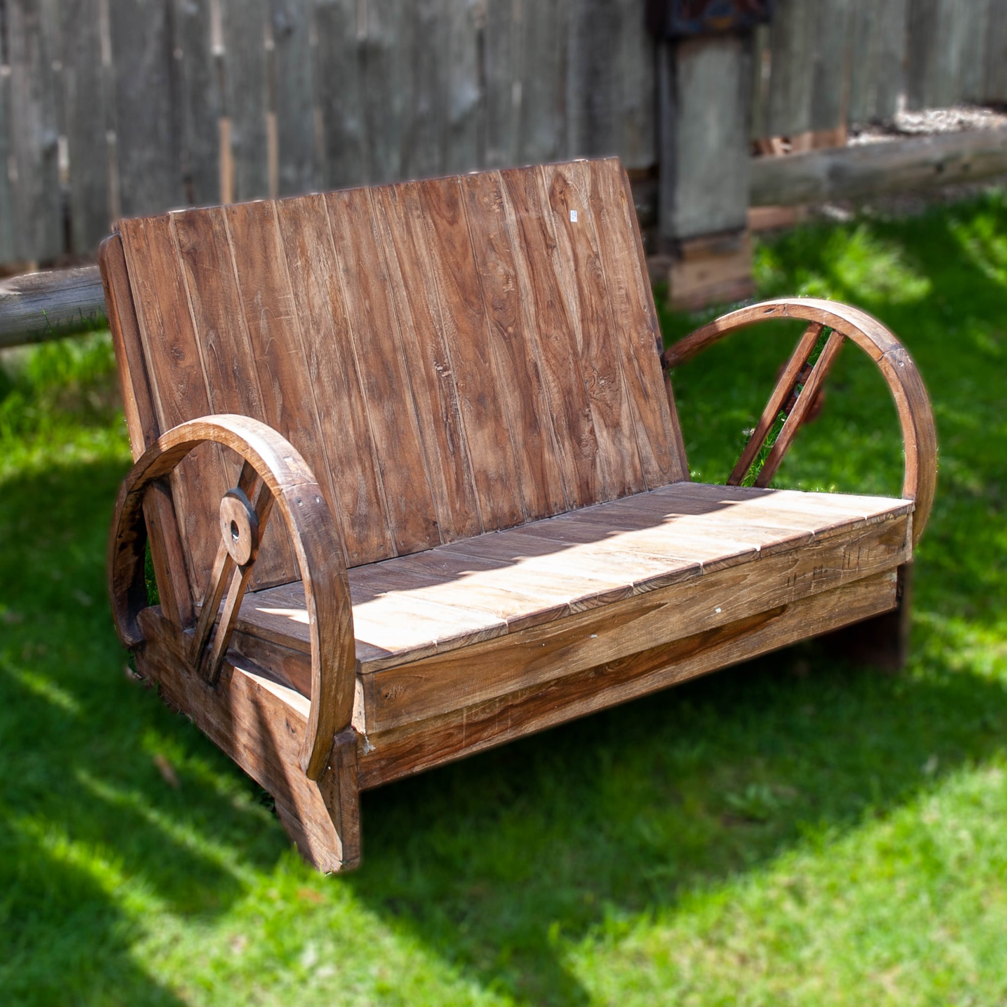 Simple wooden bench in natural wood with a laid back seat and low to the ground