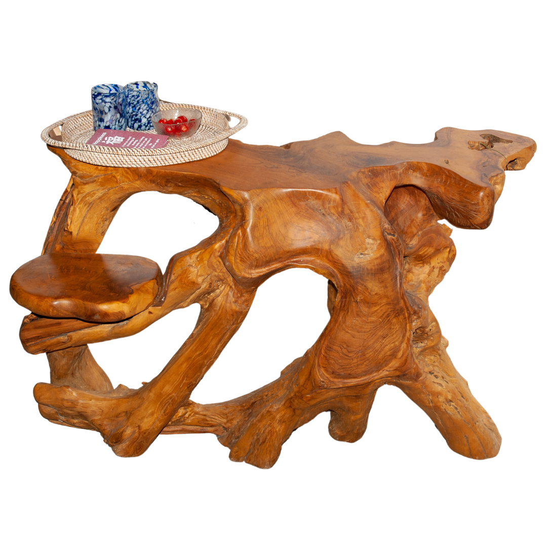 An image of a Balinese Teak Root Console. The table is expertly crafted from reclaimed teak roots, preserving their natural shapes and textures. The intricate and gnarled root structure creates a visually captivating display, while the smooth, finished surface adds a touch of refinement. It brings a sense of nature-inspired elegance to any entryway, hallway, or living space, making a statement of distinctive style.