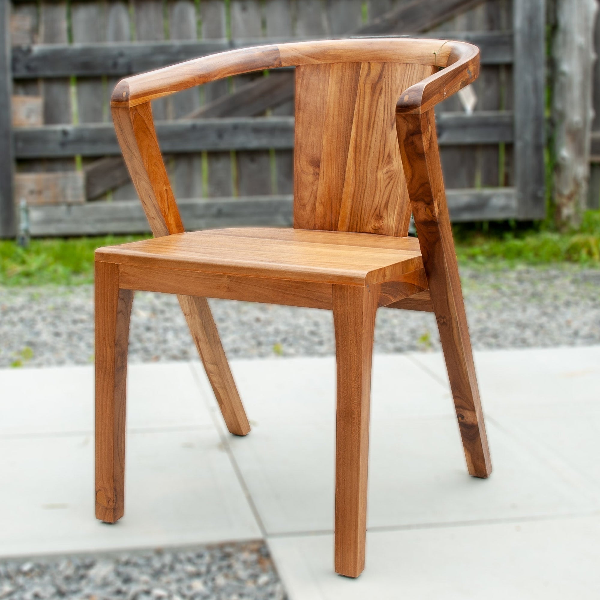 An image of a Javanese Teak Mid-Century Modern (MCM) style dining chair. The chair features a sleek design with clean lines and a minimalist aesthetic. Made from rich teak wood, the dining chair showcases the natural beauty of the wood grain, creating a warm and inviting ambiance.