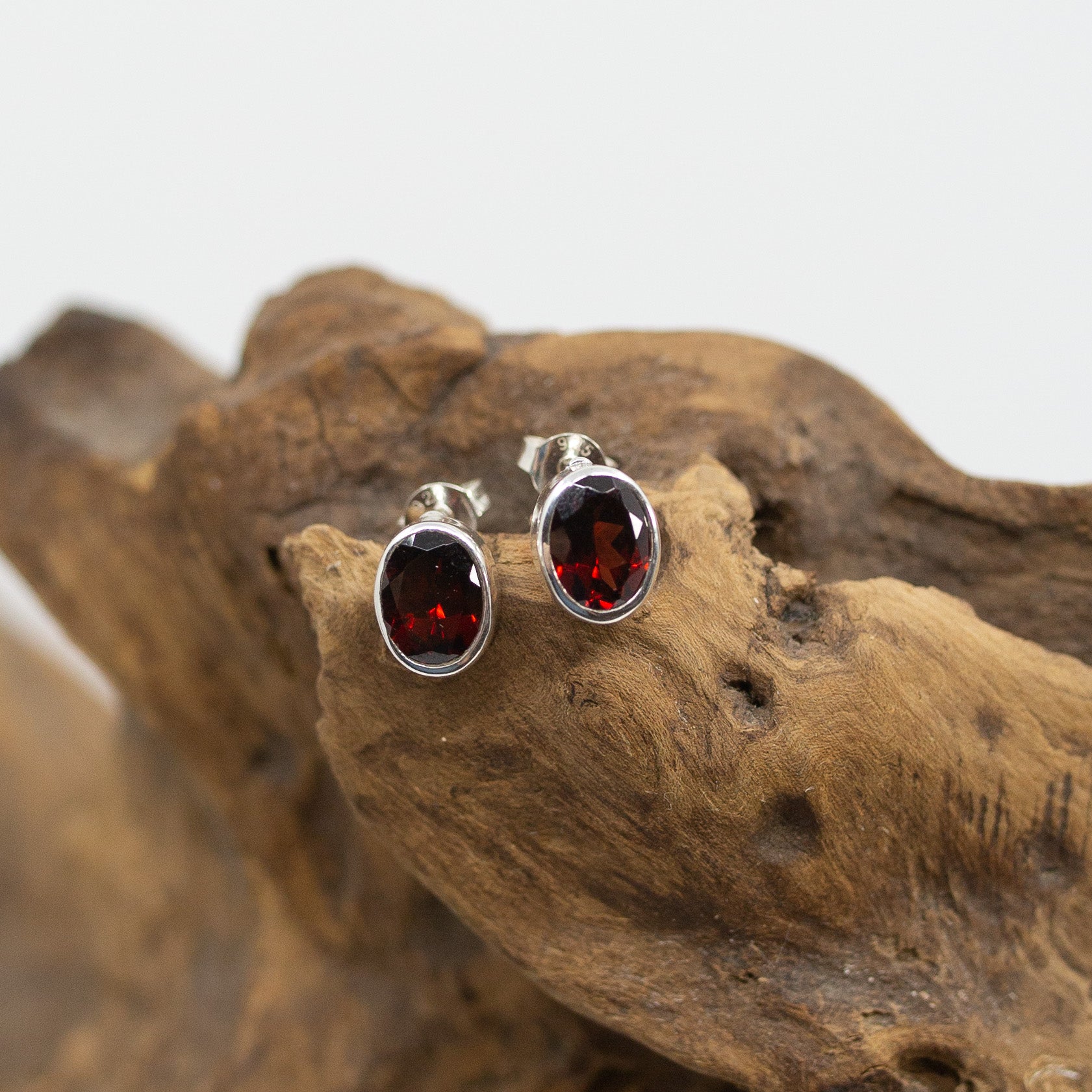 Bali Oval Garnet Stud Earrings on wood