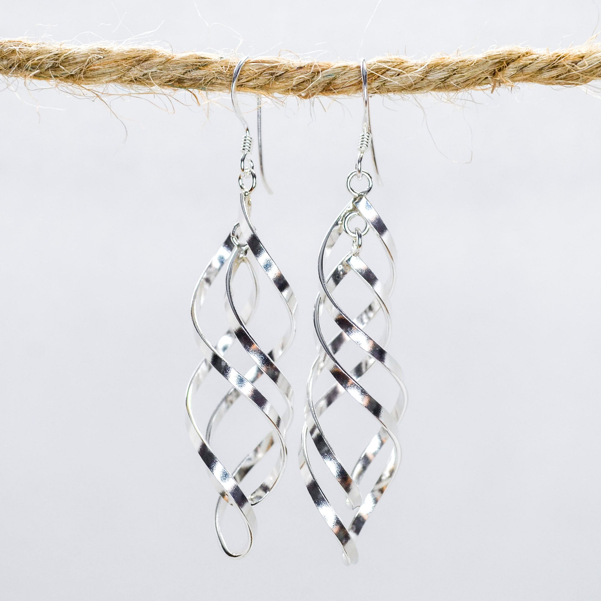 Silver Swirling sculpture dangling earrings  