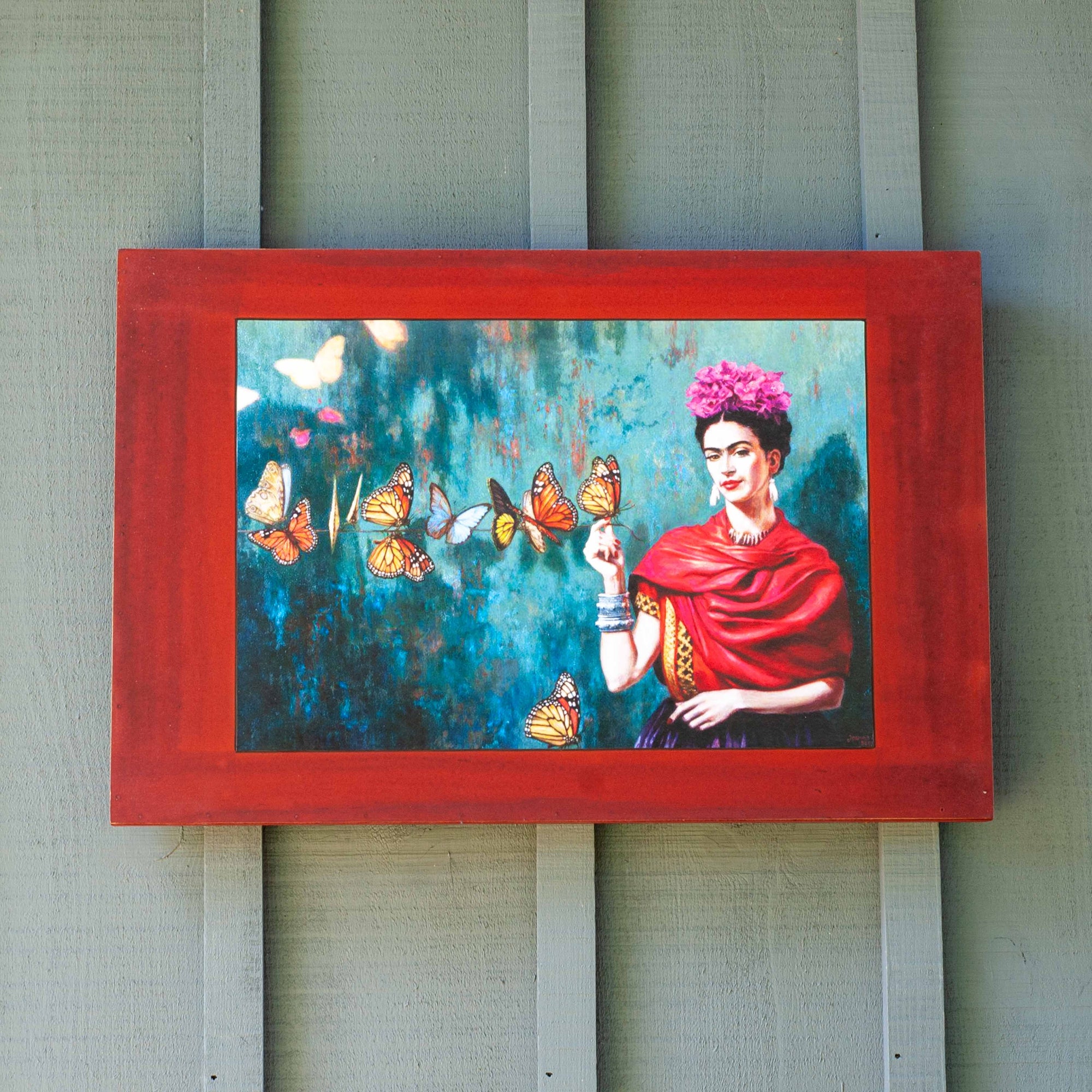 A portrait featuring Freida Kahlo with butterflies on red, wooden background