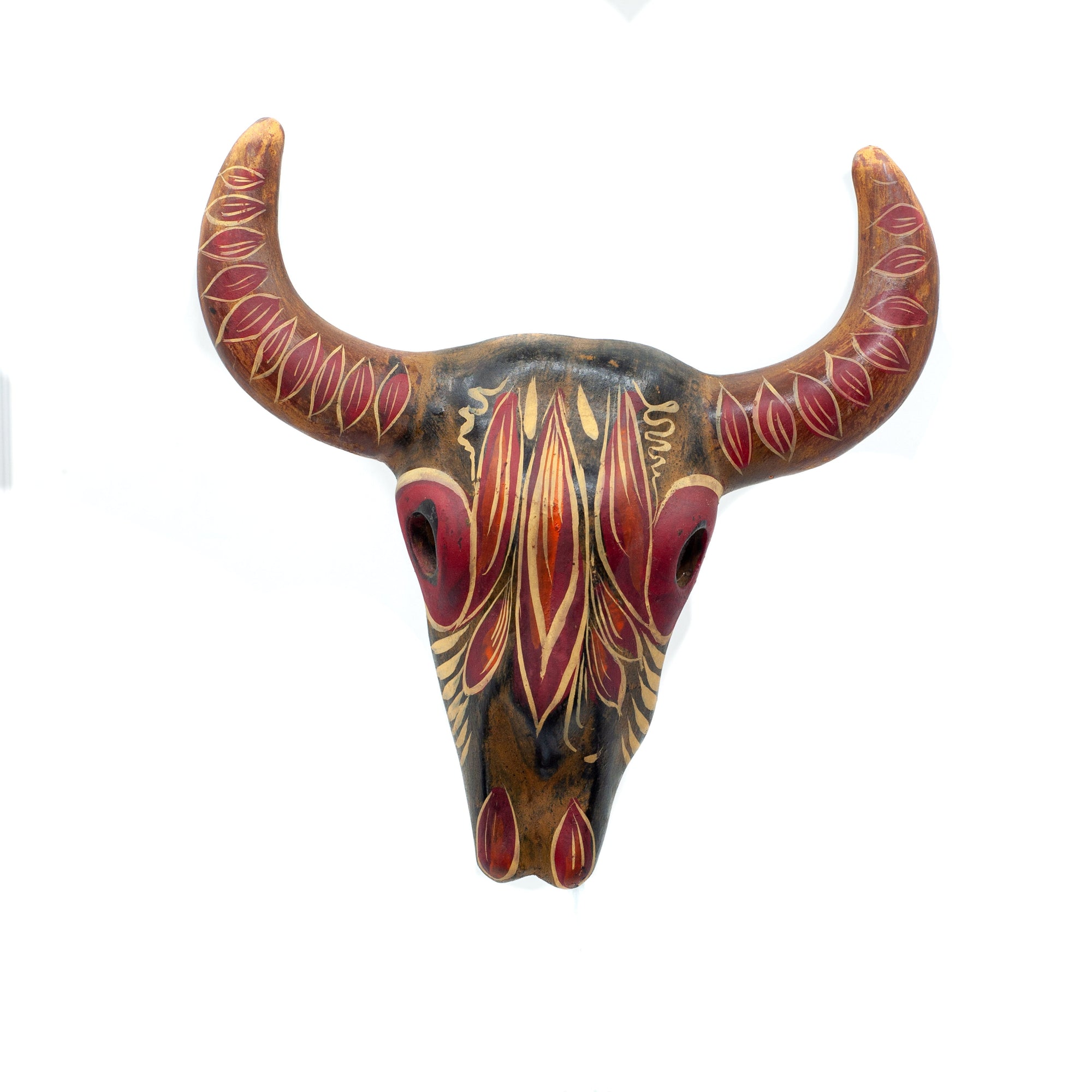 Photo of small terracotta cow skull with handpainted designs