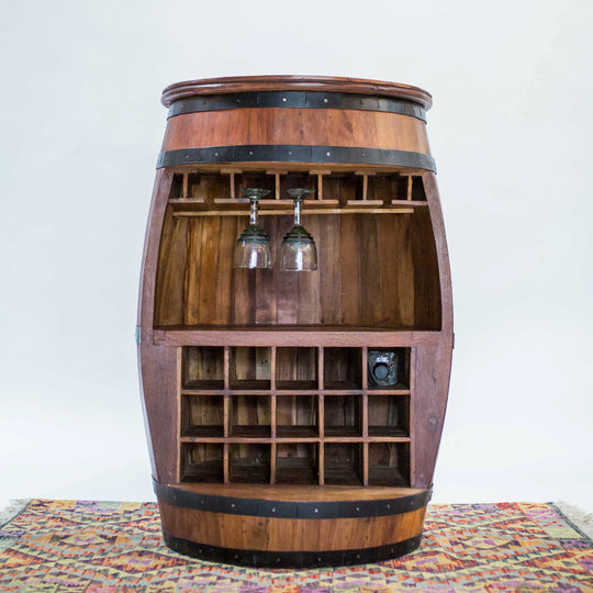 Photo of a teak wood barrel table with room for wine bottles and glasses.