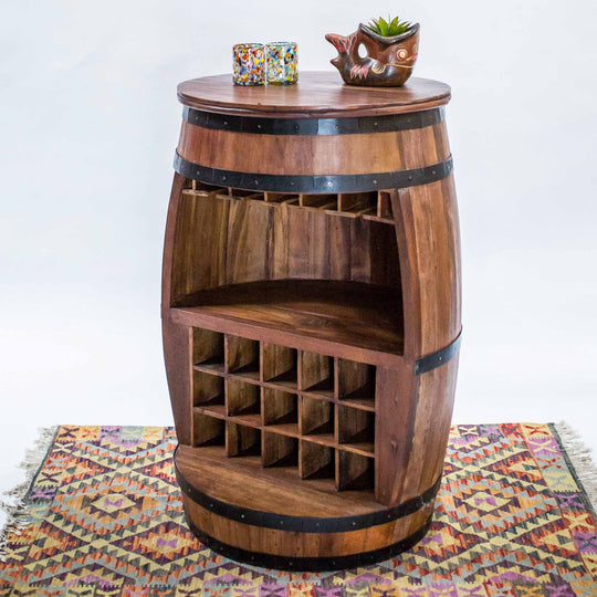 Photo of a teak wood barrel table with room for wine bottles and glasses.