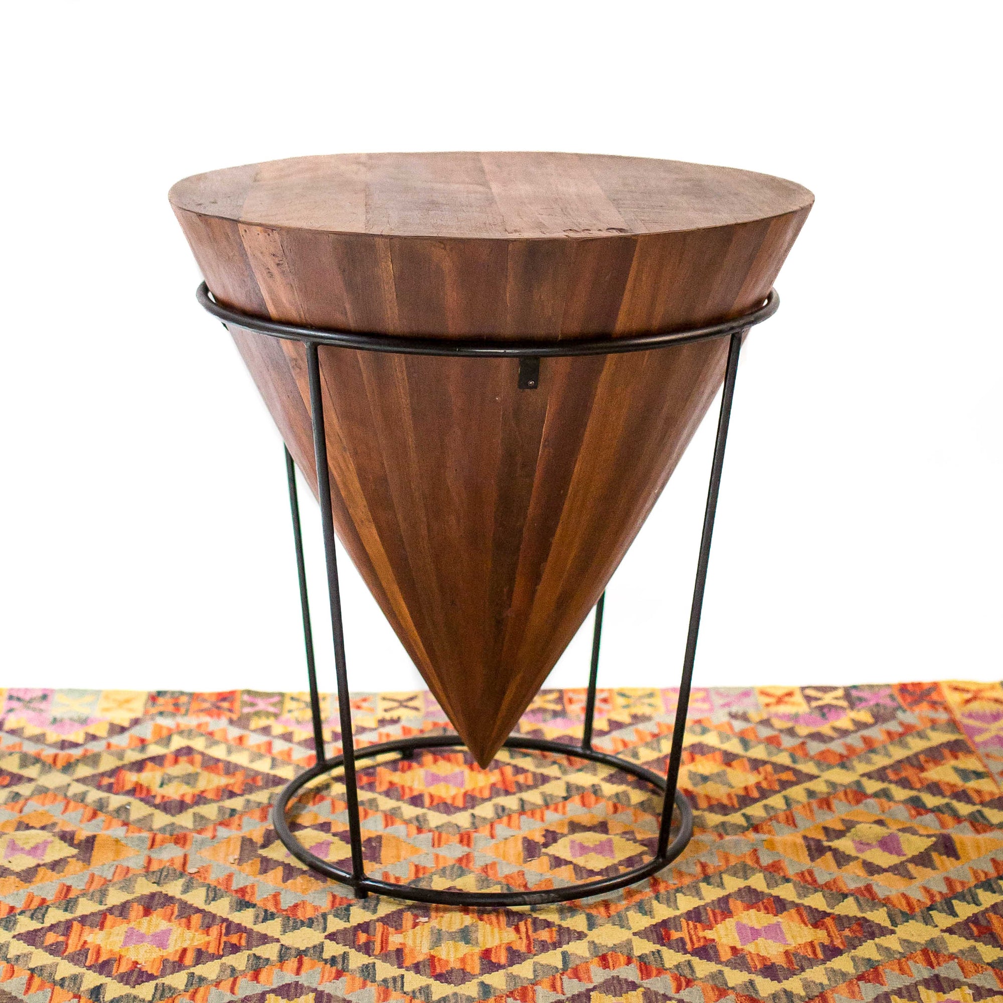 Photo of a upside down cone shaped table with metal legs 