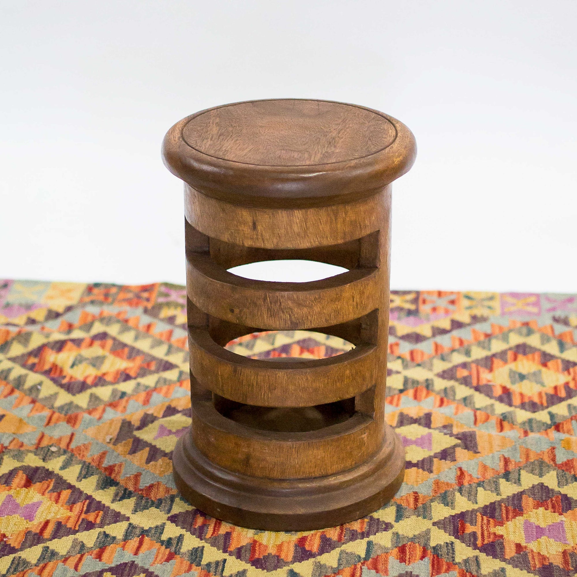 Photo of natural monkey pod wood stool with notches 