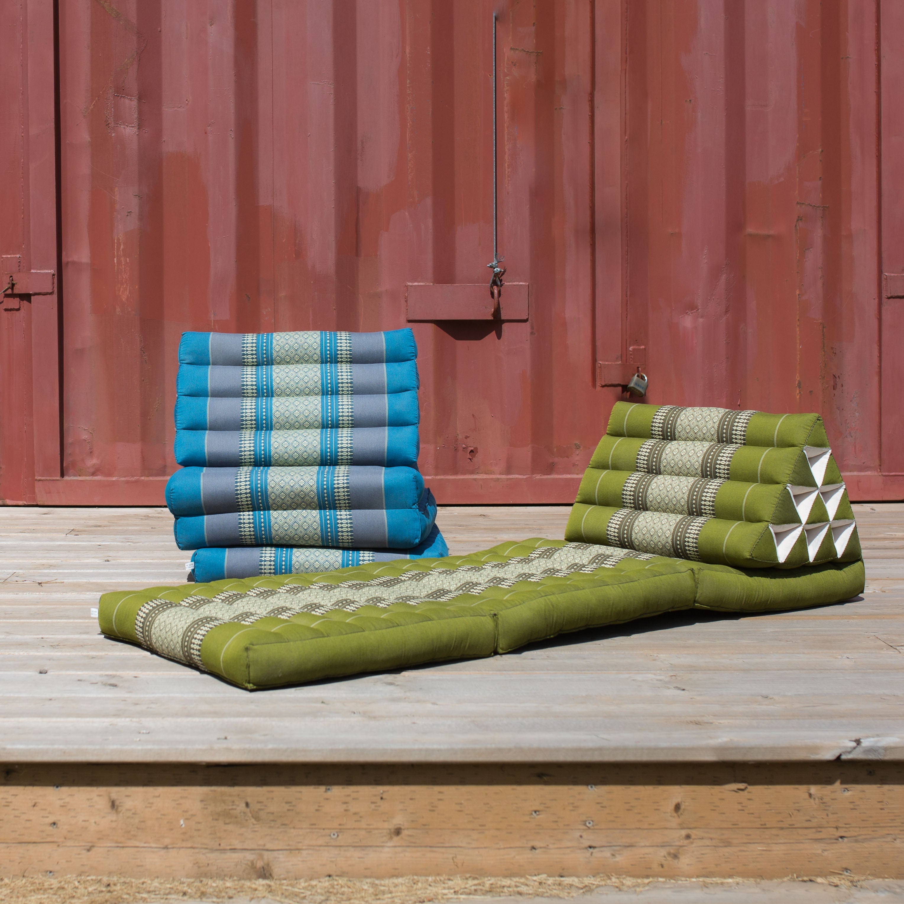 Photo of a folding yoga cushion in various positions, a blue colour and a green colour