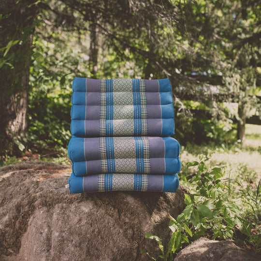 Photo of a folding yoga cushion in various positions, a blue colour and a green colour