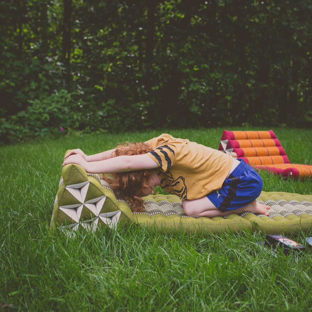 Photo of a folding yoga cushion in various positions, a blue colour and a green colour