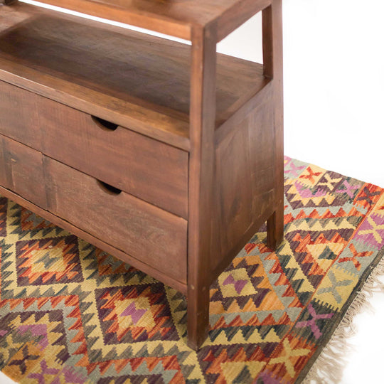 Photo of 4 drawer cabinet in a dark teak wood in an a-frame shape